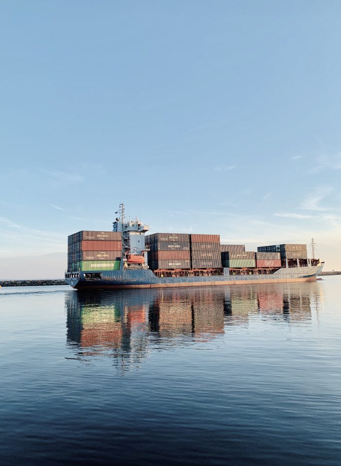 Freighter ship with metal cargo containers in the water